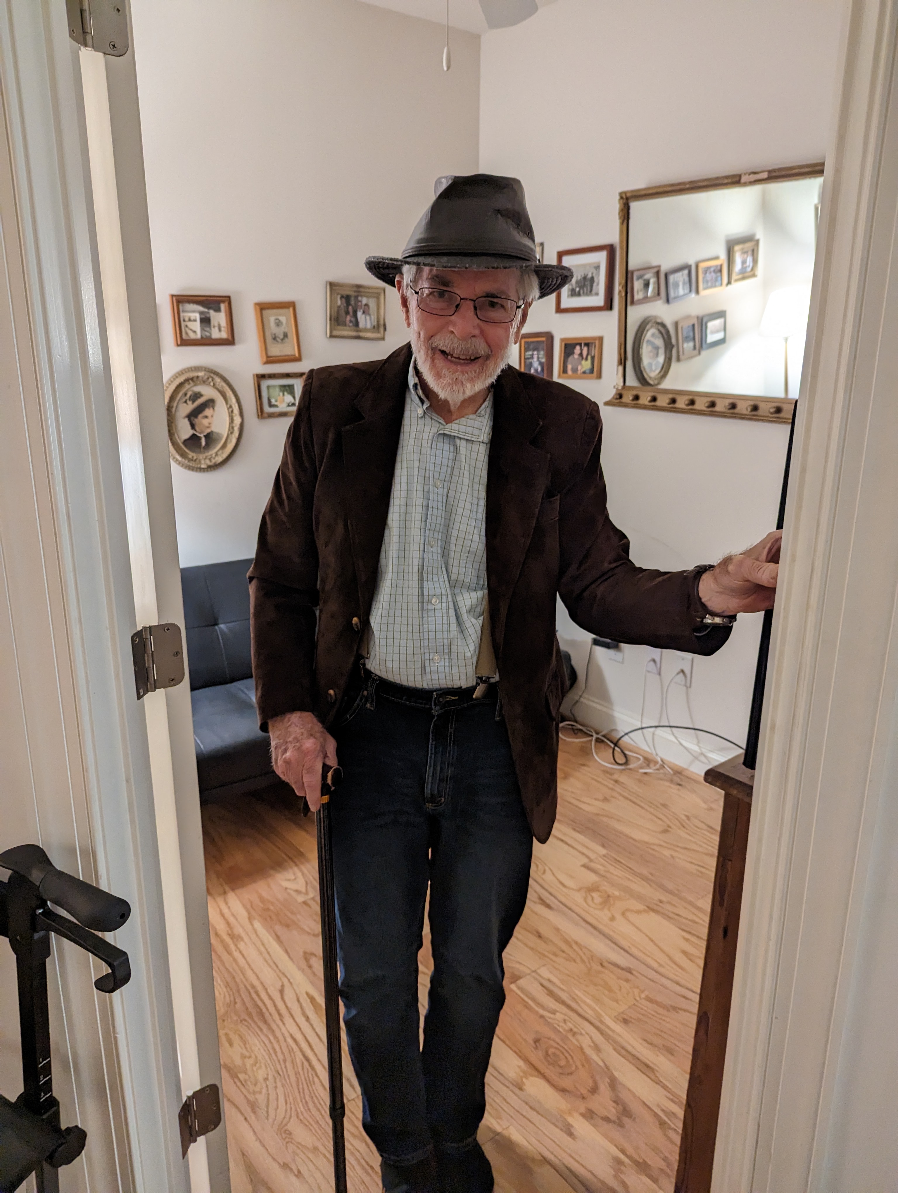 Byron in fedora, cane, doorway